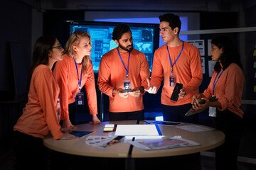 A cybersecurity team in a Security Operations Center analyzes a global threat map. They are collaborating on an incident response, tracking network intrusions in real-time.