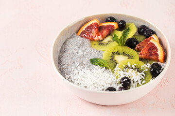 Healthy breakfast bowl with chia pudding, kiwi, blood orange, and berries