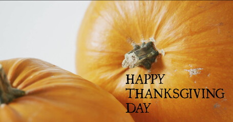 Image of happy thanksgiving day text over autumn pumpkins on white background
