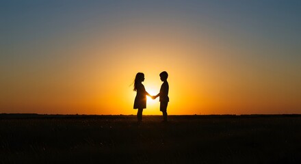 Silhouette of children holding hands at sunset on a hilltop, symbolizing unity and hope