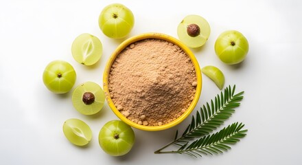 Vegan protein powder a yellow bowl filled with amla powder surrounded by fresh amla fruits and a green sprig on a white background, showcasing indian gooseberry