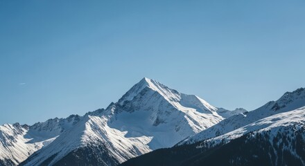 Fototapeta premium Snow-capped mountain peak against clear blue sky