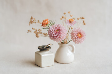 beautifully arranged scene featuring vintage stationery and dried flowers on soft linen backdrop