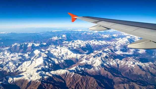 Aerial view of snow-capped mountains from airplane window