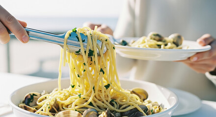 Elegant seaside dining with fresh spaghetti alle vongole, served under warm sunlight for a luxurious Italian coastal food and travel experience
