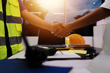 Closeup of team of industrial engineers meeting analyze machinery blueprints consult project on table in manufacturing factory. Working in manufacturing plant or production plant.