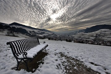 Snowy hilltop view, black park bench