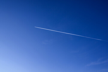 irplane trail in the blue sky