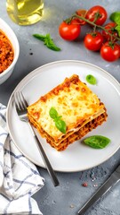 A slice of lasagna on a plate, garnished with basil and cheese