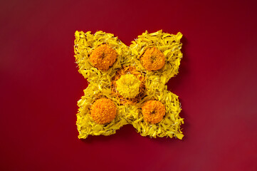 Diwali festival background with colorful decoration marigold flowers on dark red background.