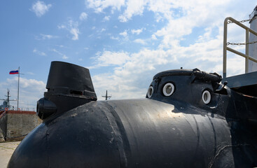 A fragment of a small submarine with a wheelhouse, portholes and a searchlight © Sergey