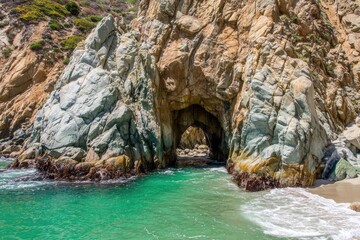 Coastal archway through rocky cliffs