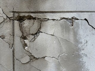Cracked Concrete Wall Texture. cracked and damaged concrete wall surface, showing structural decay,...