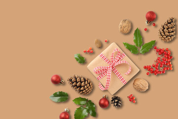 A lovely gift sits among festive pinecones and berries