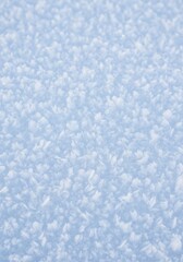 Obraz premium Close Up of Sparkling Blue and White Snow Crystals Covering a Flat Surface in Winter