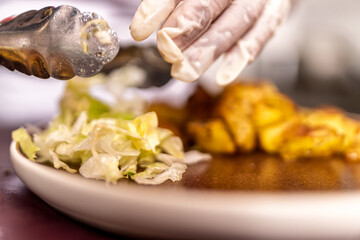 Chef preparing fried food with fresh salad