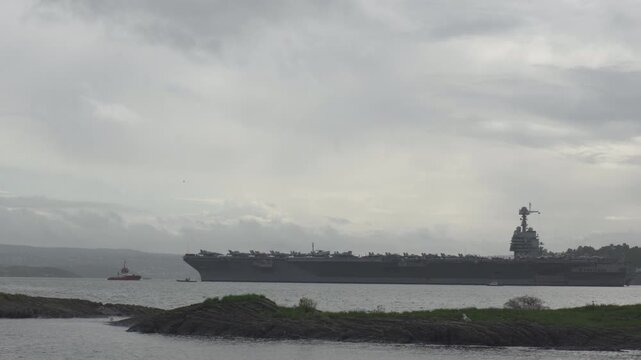 USS Gerald R. Ford Aircraft Carrier Navigating In The Fjord In Oslo, Norway. - wide shot