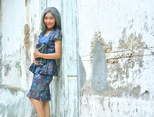 Indonesian women pose wearing batik clothes