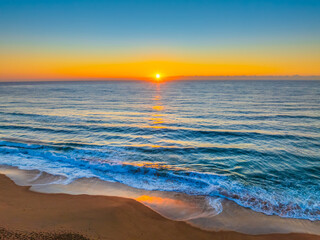 Fototapeta premium Sunrise at the Seaside with Clear Blue Skies