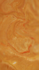 Golden splash. Wet texture. Blur yellow orange color paint flowing in water acrylic blend wave spreading on abstract art background.