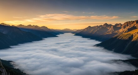 Obraz premium Breathtaking panoramic view of a majestic mountain valley filled with a sea of clouds, illuminated by golden hour light during sunrise or sunset, creating a serene and epic natural landscape.
