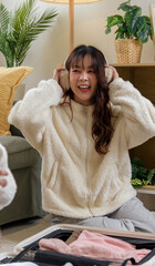 Winter day inspires warm friendship, women friends enjoy home comfort, cozy clothing earmuffs for winter journeys, happy cheerful moments at home preparing for adventure © sorapop