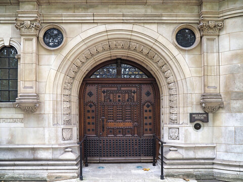 Ornate carved wooden entrance to Millbank House, an ornate old office building in London