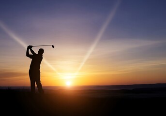 Silhouette of a golfer swinging a golf club against a sunset sky during a game