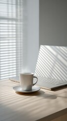 Obraz premium Warm Coffee Beside Laptop in Sunlit Office