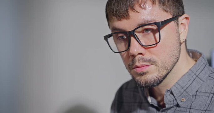 Closeup young adult male freelance developer typing write prompt AI bot app program nomad terminal with coding at office. Artificial intelligence dashboard, robotics, user interface, machine learning.