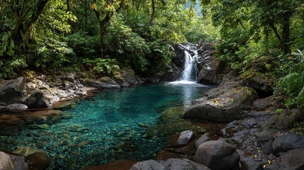 Fototapeta premium A tranquil turquoise pool nestled beneath a lush rainforest waterfall, showcasing a serene natural scene.