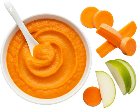 Bowl of vibrant orange puree sliced carrots and green apple wedges with a spoon isolate food baby food - Powered by Adobe