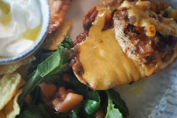 Delicious grilled chicken with melted cheese and fresh salad