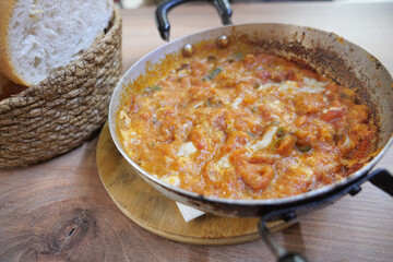 Delicious turkish menemen served in a rustic pan 