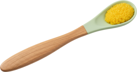 Light green silicone spoon with wooden handle holds yellow roe or small grains isolate food macro ingredient