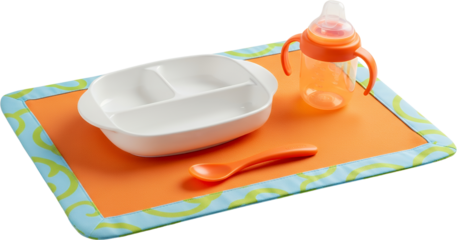 Divided white toddler plate orange sippy cup and spoon on a colorful mat with a playful design divided plate transparent background