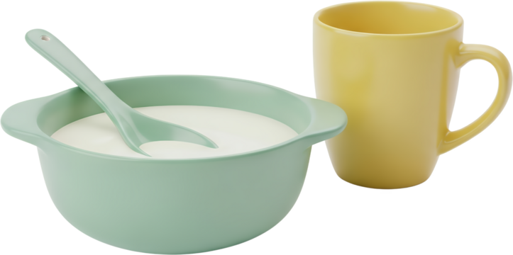 A light blue bowl filled with white creamy substance and a light green spoon next to a yellow mug isolate