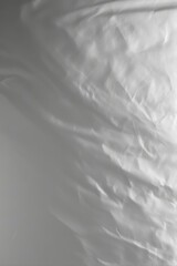 Obraz premium Gentle folds of white fabric with soft shadows and subtle texture.