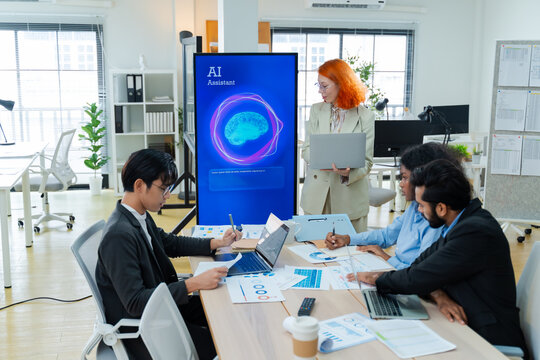 Diverse creative team use Ai Assistant (artificial intelligence assistant) on AI-assisted display for Marketing Data Analyst meeting at office.Coding team,develop Ai Assistant,business brainstorming