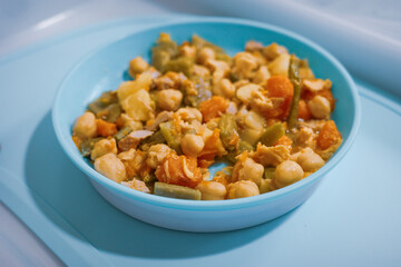 Homemade chickpea and vegetable stew in blue bowl
