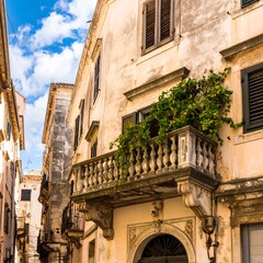 Old European alleyway with ornate balcony