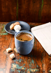 Cup of coffee on rustic wooden background. Soft focus. Copy space	