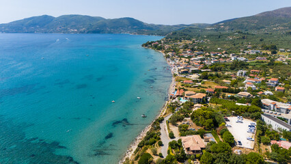 Zakynthos Greece aerial view of Laganas coastline with turquoise and deep blue Ionian Sea clear shallow waters and seaside village houses