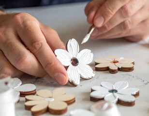 Hands painting white flowers