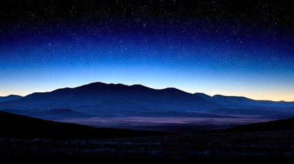 Night sky over a vast, dark mountain range.