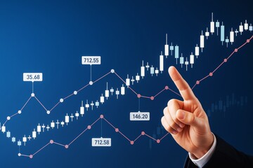 Business hand pointing at rising stock market candlestick chart with price data points on blue background illustrating financial growth concept.