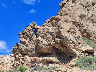 Huge rock against the blue sky.