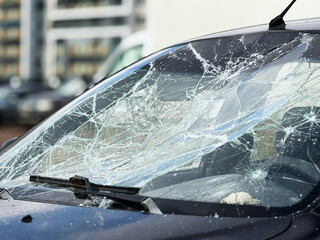 A broken windshield of a car due to burglary, vandalism, theft. Dangerous, careless, unsafe, drunk,...