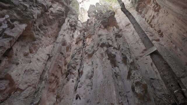 Low angle camera movement looking up through a narrow canyon in los estoraques, colombia