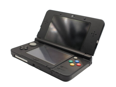 Portable handheld gaming console in black color, opened and isolated on white background. Perfect for concepts of retro gaming